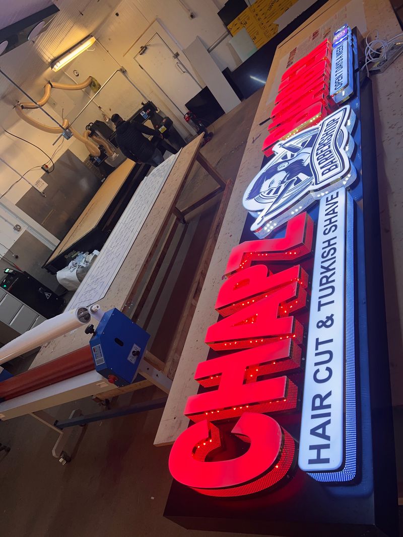 Red illuminated built-up letters for Chan hair and Turkish shave