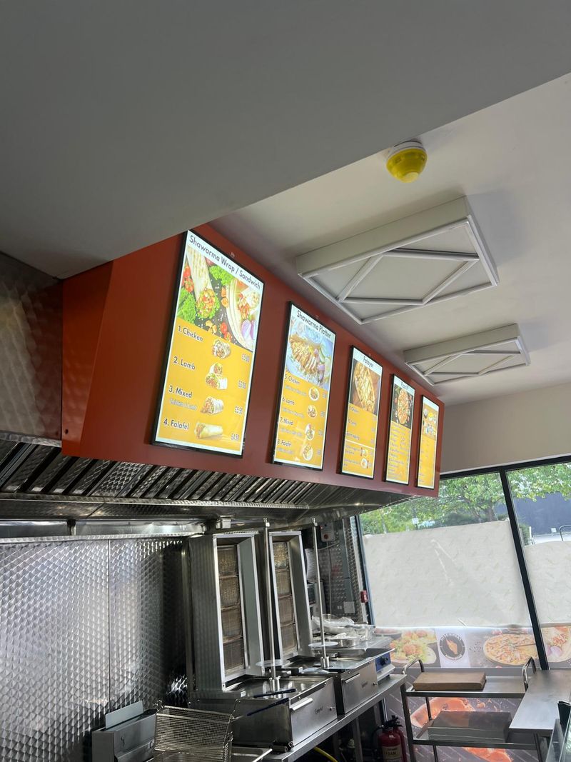 Illuminated menu boards and counter fit-out for a fast food takeaway