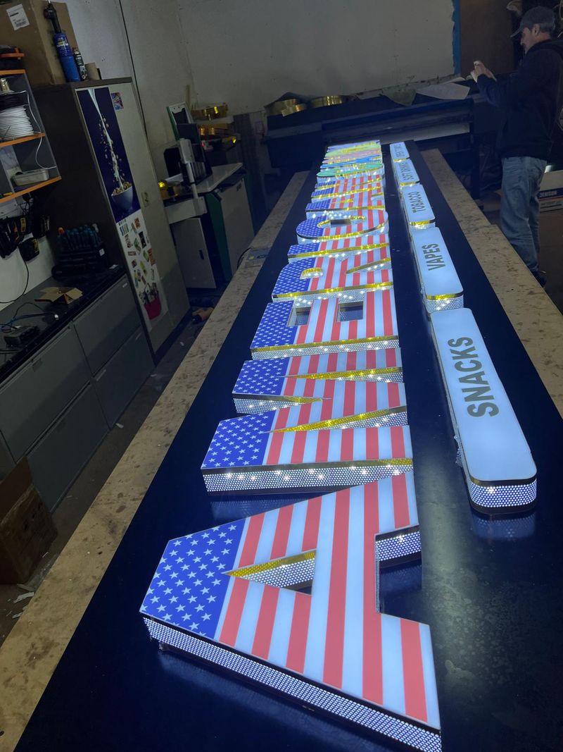 Illuminated built-up letters wrapped with printed flag graphics