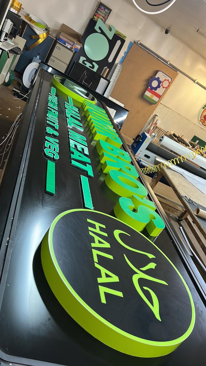 Green illuminated Halal lightbox sign for a restaurant