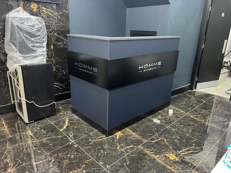 Bespoke marble-effect reception counter shop fitting for Homme Barbers