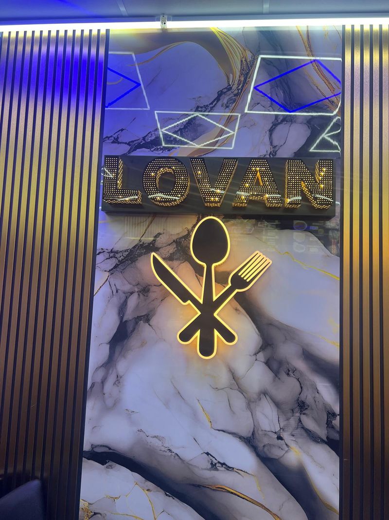 Gold built-up letters on a marble-effect fascia for Lovan