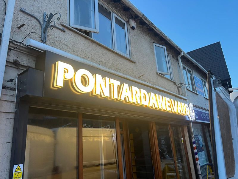 Gold illuminated fascia lettering for a shopfront