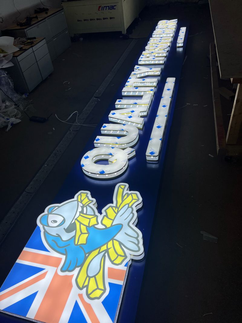 Illuminated fascia tray sign with Union Jack graphics for a quality shop