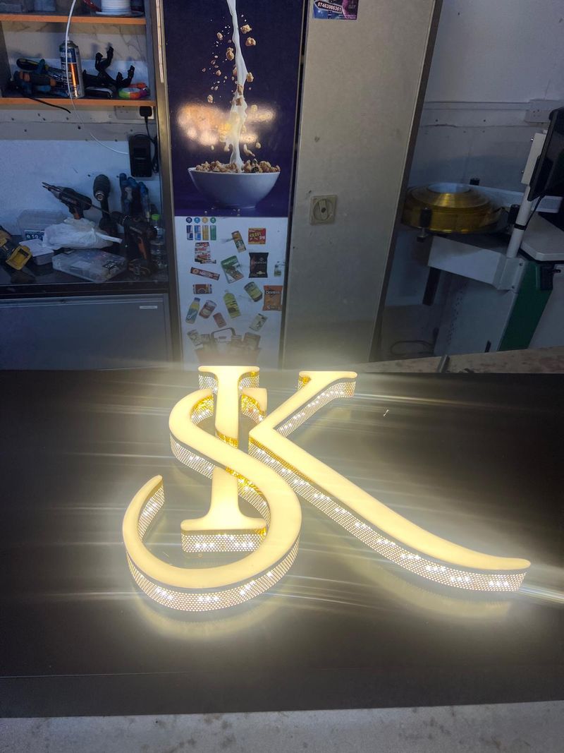 Gold illuminated SK monogram with neon detailing for a barber