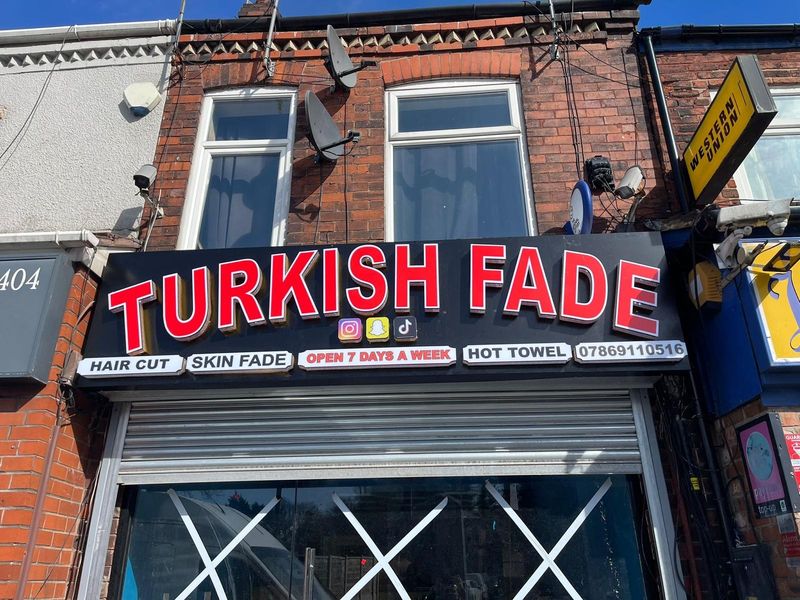 Red illuminated Turkish Fade barbers shopfront fascia